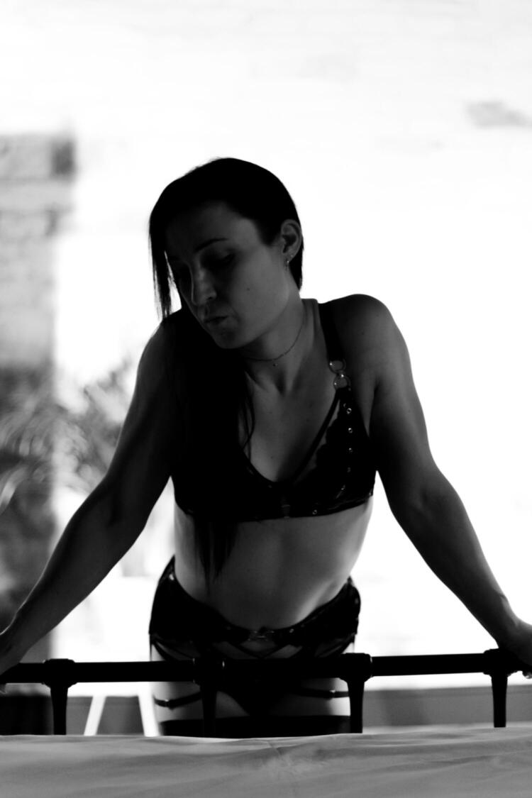 Trans escort Raye Wilde posing in black and white photo in Wakefield apartment